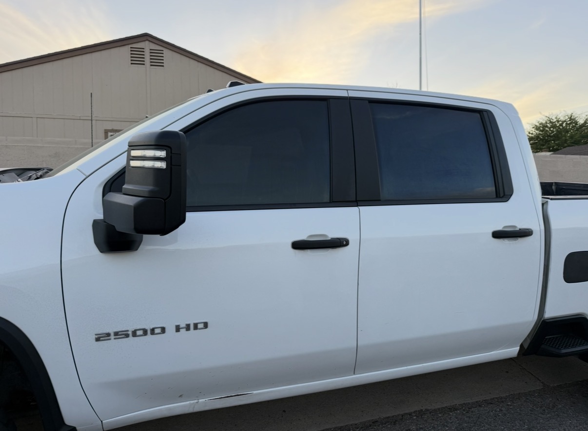 White Chevy Silverado 2500HD with full side tint