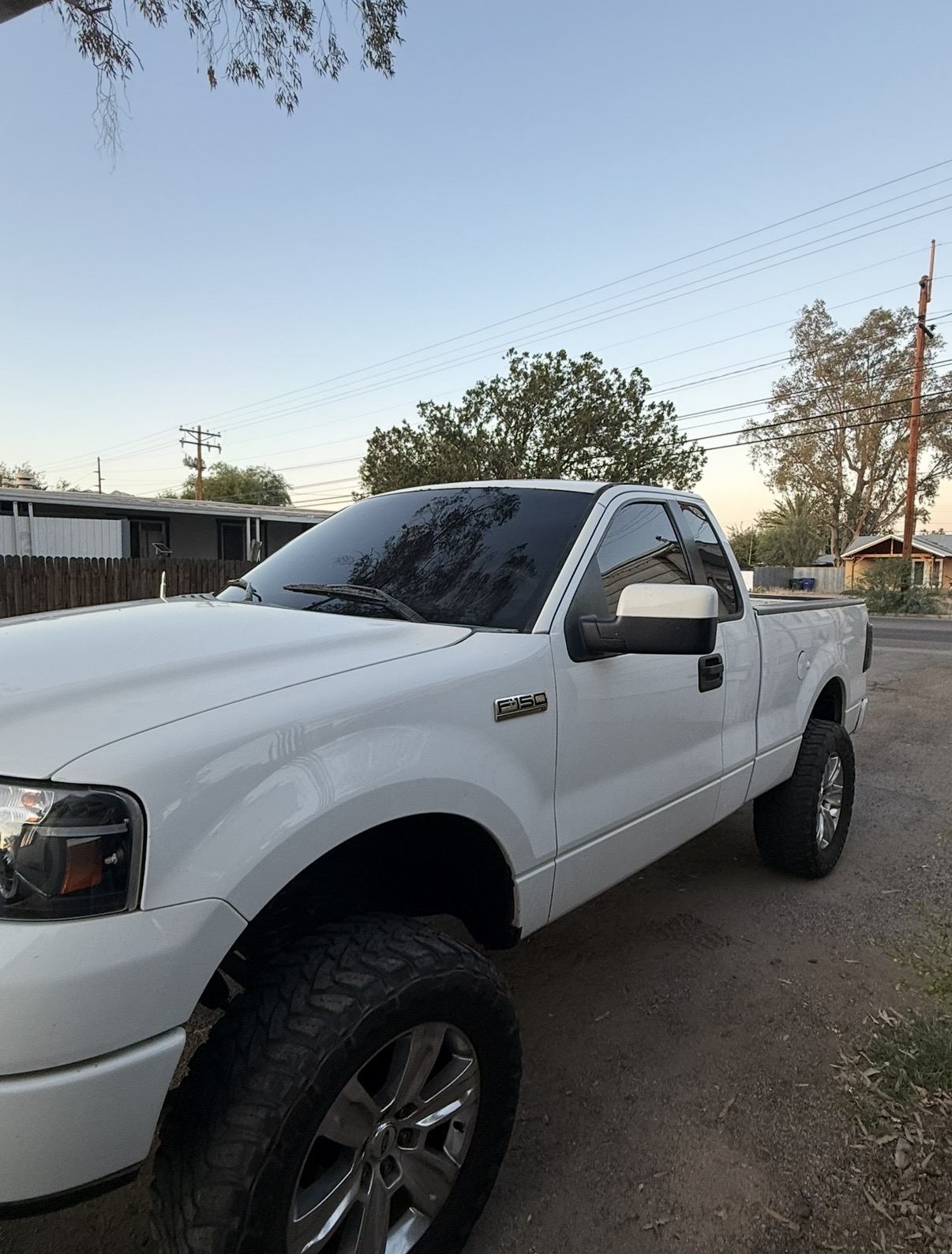 White lifted Ford F-150 with side tint installed
