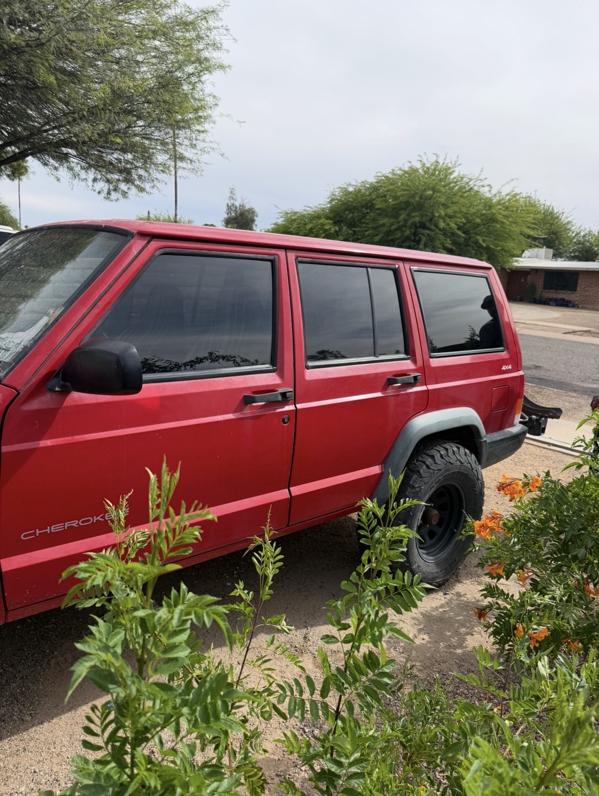 Red Jeep Cherokee with side window tint